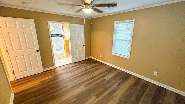 unfurnished bedroom with ornamental molding, dark wood finished floors, and baseboards