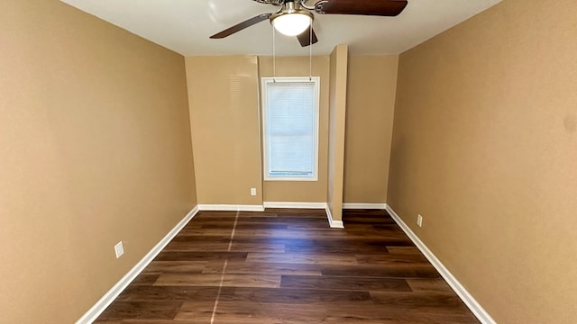 empty room with ceiling fan, baseboards, and dark wood-style flooring