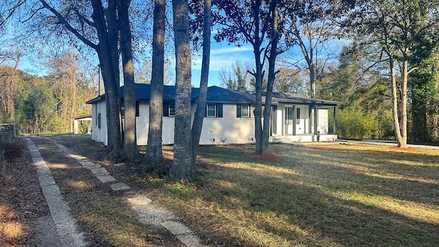 view of property exterior with crawl space, brick siding, and a yard