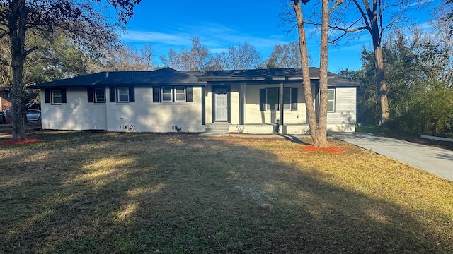 single story home with covered porch, a front lawn, and brick siding