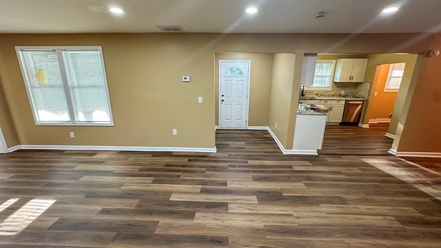 interior space with dark wood-style floors, recessed lighting, visible vents, and baseboards