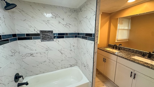 bathroom featuring marble finish floor, tub / shower combination, a sink, and double vanity