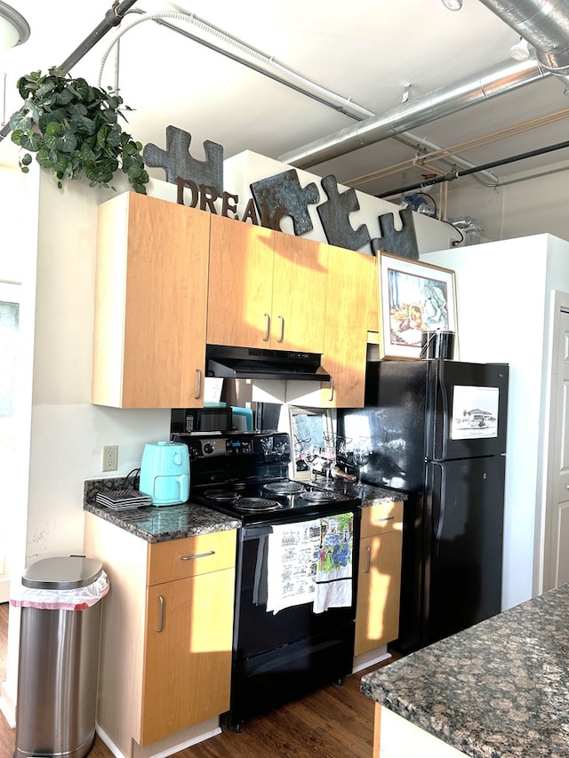 kitchen featuring black appliances, dark hardwood / wood-style flooring, and dark stone countertops