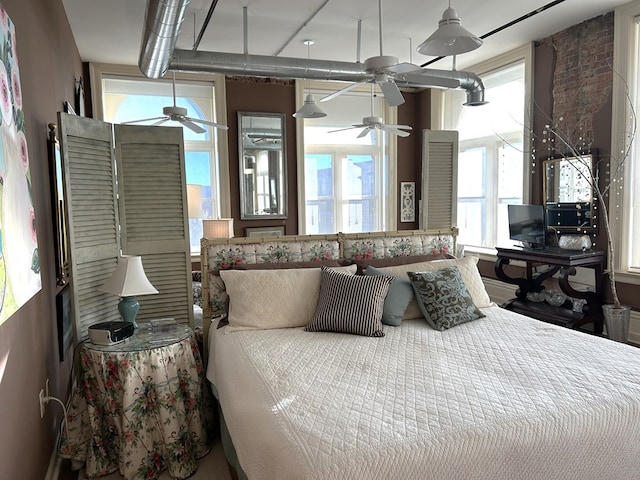 bedroom featuring multiple windows and ceiling fan