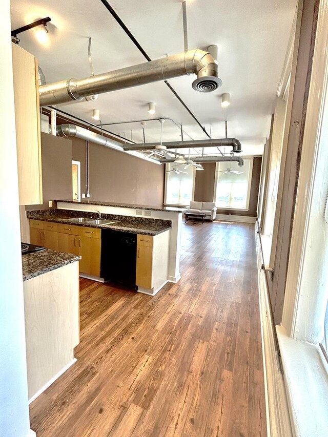 kitchen with kitchen peninsula, black electric range oven, and dark stone counters