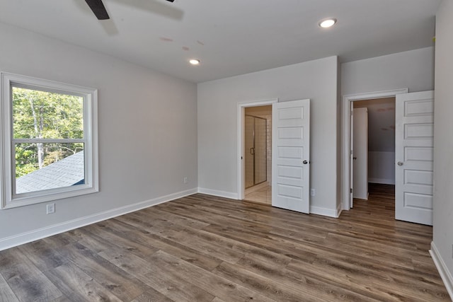 unfurnished bedroom featuring ceiling fan, dark hardwood / wood-style flooring, and ensuite bathroom