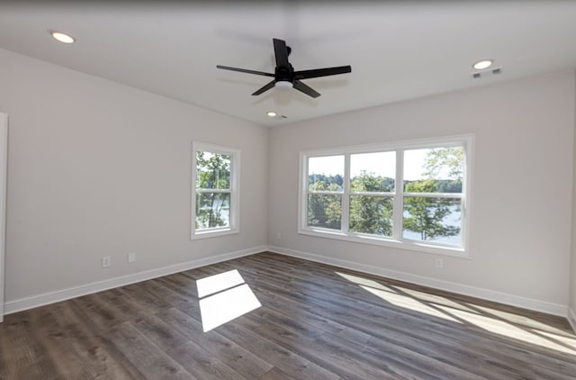 spare room with ceiling fan and dark hardwood / wood-style flooring