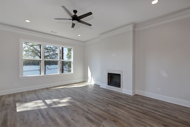 unfurnished living room featuring ceiling fan, dark hardwood / wood-style floors, and ornamental molding