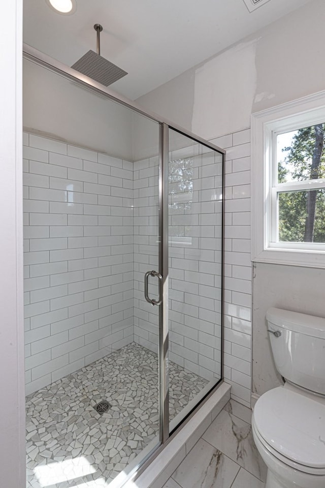 bathroom featuring toilet and walk in shower