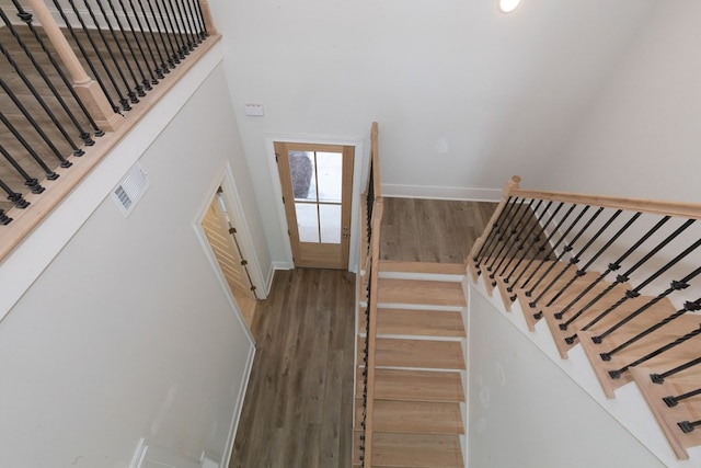 staircase with hardwood / wood-style floors