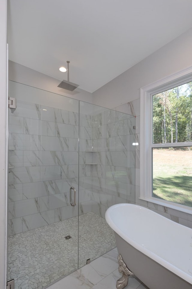 bathroom with separate shower and tub