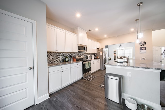 kitchen featuring dark hardwood / wood-style flooring, light stone counters, stainless steel appliances, sink, and white cabinetry