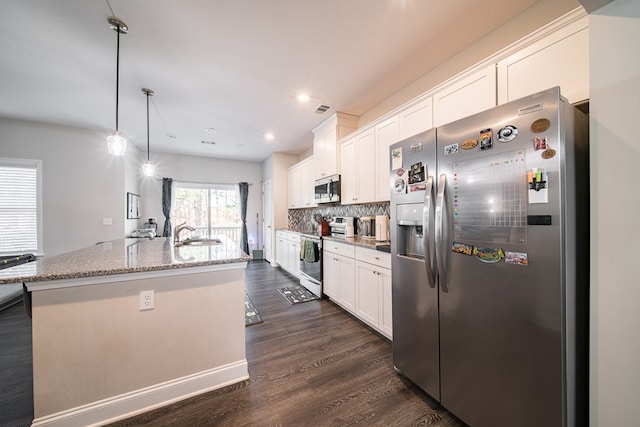 kitchen featuring white cabinetry, dark wood-type flooring, an island with sink, and stainless steel appliances