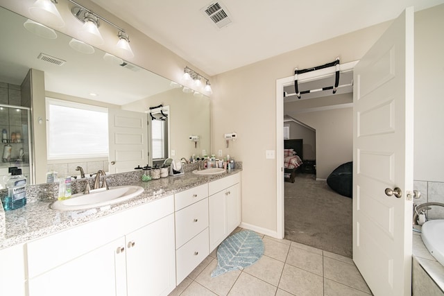 bathroom with tile patterned floors, vanity, and shower with separate bathtub