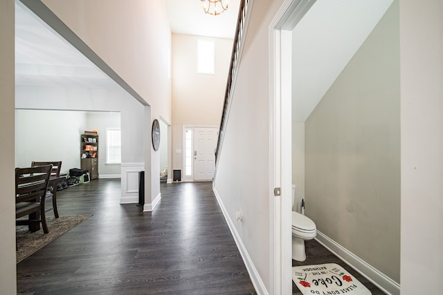 corridor featuring dark hardwood / wood-style flooring and a notable chandelier