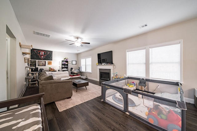 living room featuring dark hardwood / wood-style floors and ceiling fan