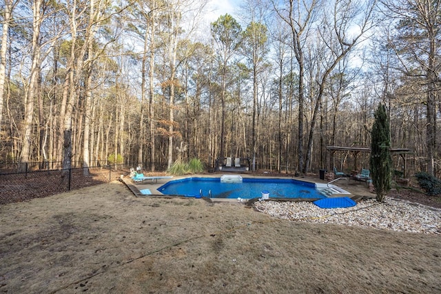 view of pool with a diving board and a yard