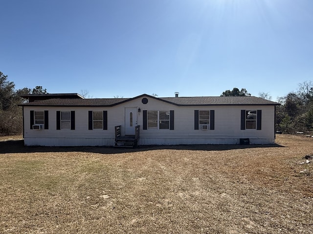 manufactured / mobile home featuring a front yard and cooling unit