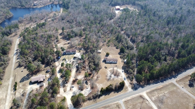 aerial view featuring a water view and a wooded view