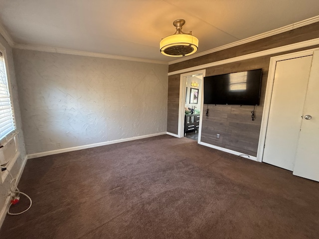 interior space with baseboards, a textured wall, and crown molding