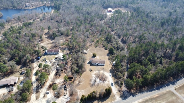 birds eye view of property featuring a view of trees