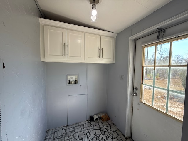 washroom featuring hookup for a washing machine, cabinet space, and plenty of natural light