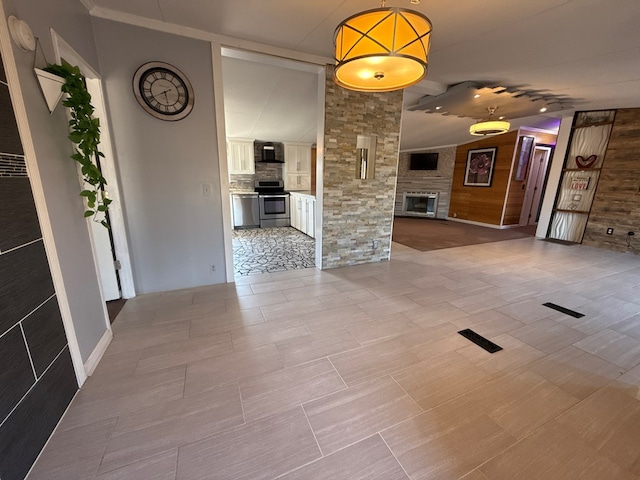 interior space featuring lofted ceiling and a large fireplace