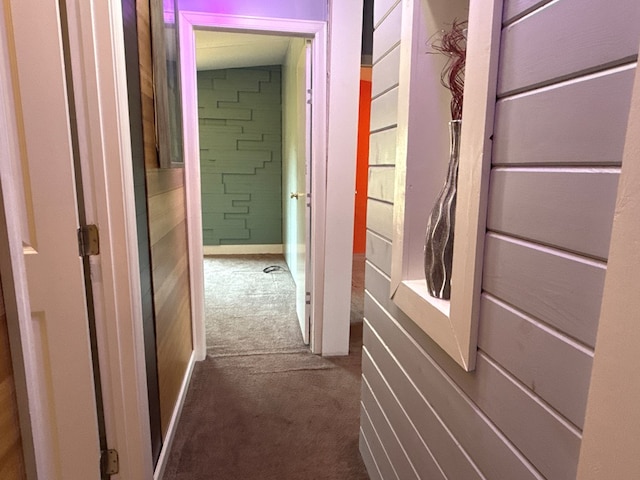 hallway featuring dark carpet