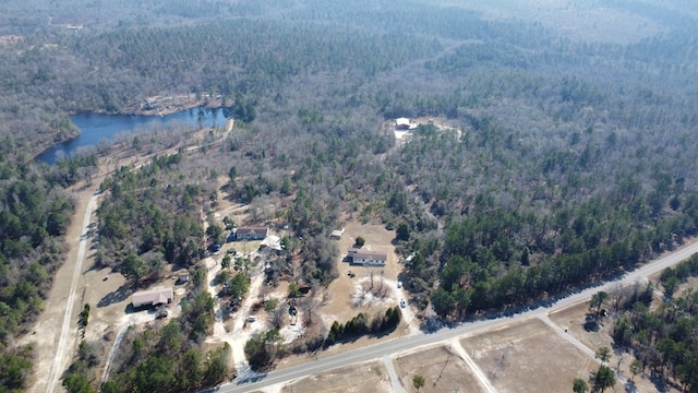 bird's eye view with a forest view and a water view