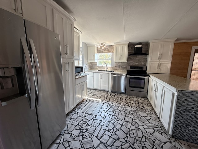 kitchen with white cabinets, wall chimney range hood, stainless steel appliances, and a sink