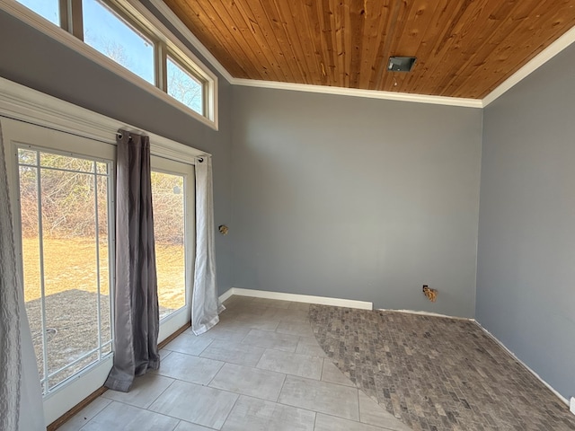 spare room featuring ornamental molding, wood ceiling, baseboards, and tile patterned floors