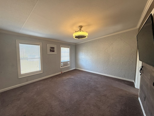 empty room with dark colored carpet, a textured wall, ornamental molding, a textured ceiling, and baseboards