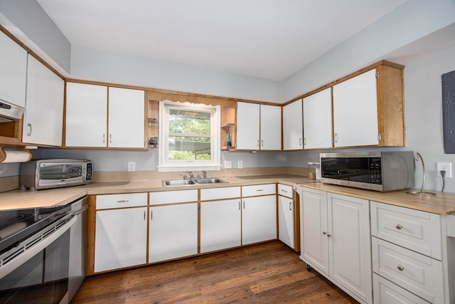 kitchen with white cabinets, appliances with stainless steel finishes, dark wood-type flooring, and sink