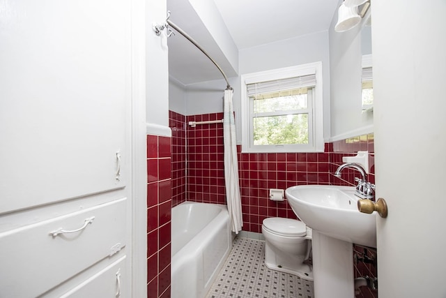 bathroom with shower / bath combination with curtain, toilet, and tile walls