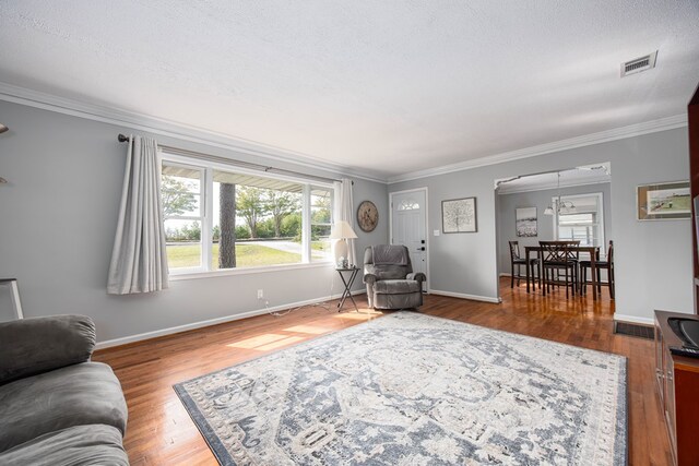 living room with hardwood / wood-style flooring and ornamental molding