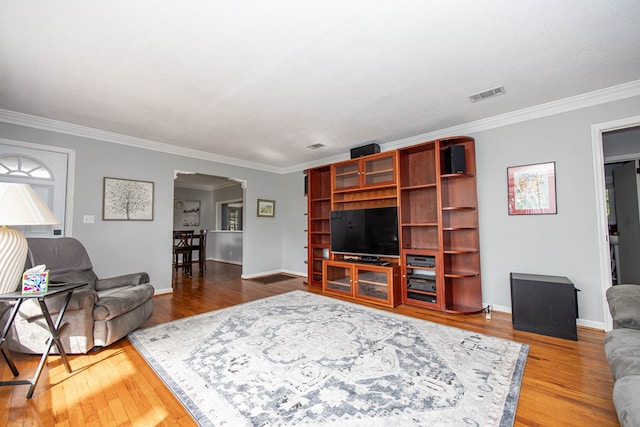 living room featuring hardwood / wood-style flooring and ornamental molding