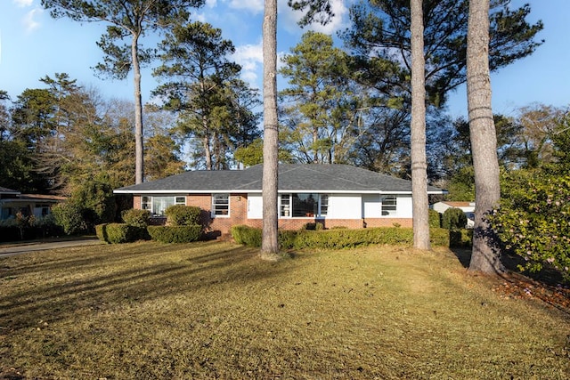 ranch-style home with a front lawn