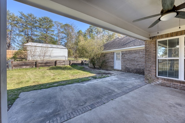 view of patio with ceiling fan and fence