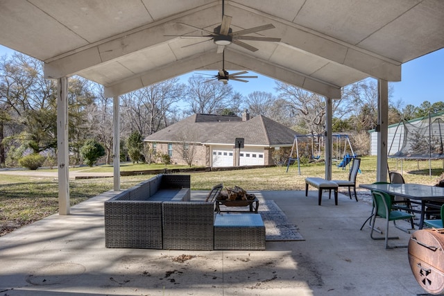 view of patio / terrace featuring an outdoor living space, a trampoline, playground community, outdoor dining area, and a ceiling fan