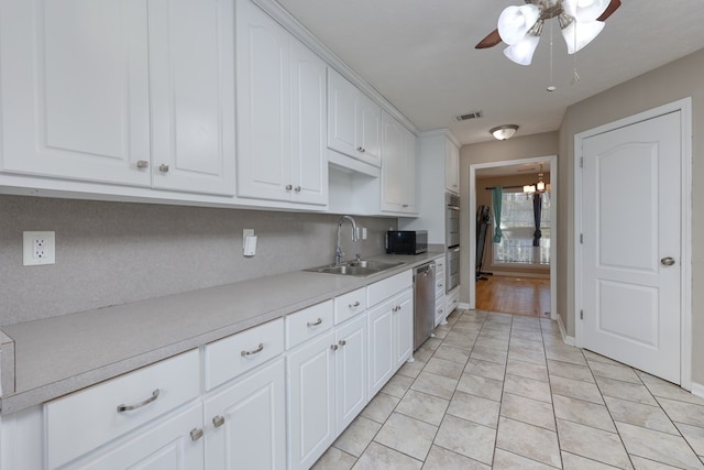 kitchen with visible vents, ceiling fan, a sink, light countertops, and appliances with stainless steel finishes