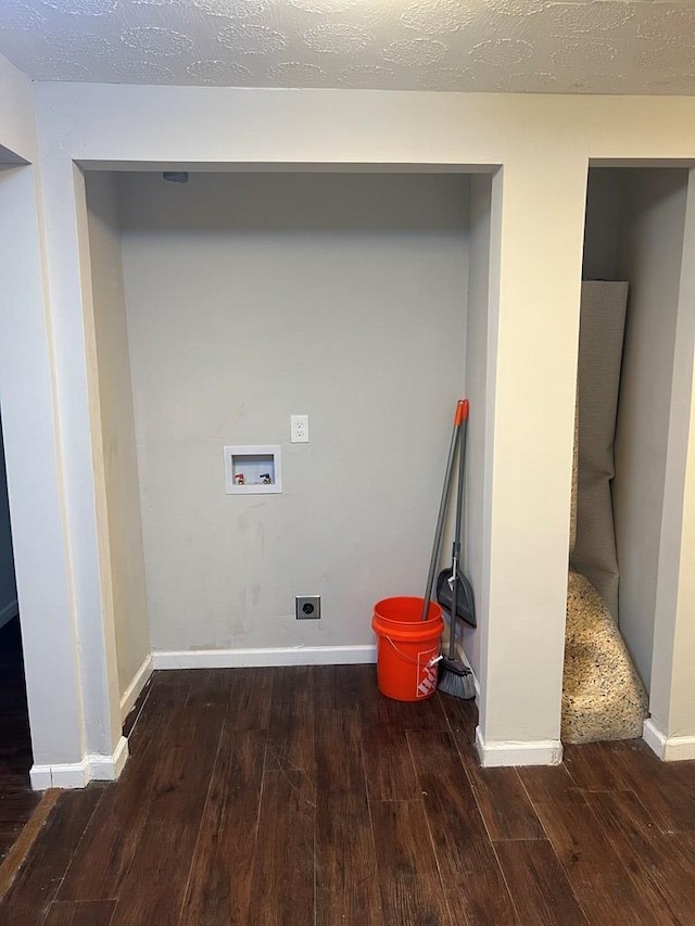 clothes washing area with washer hookup, electric dryer hookup, dark hardwood / wood-style flooring, and a textured ceiling