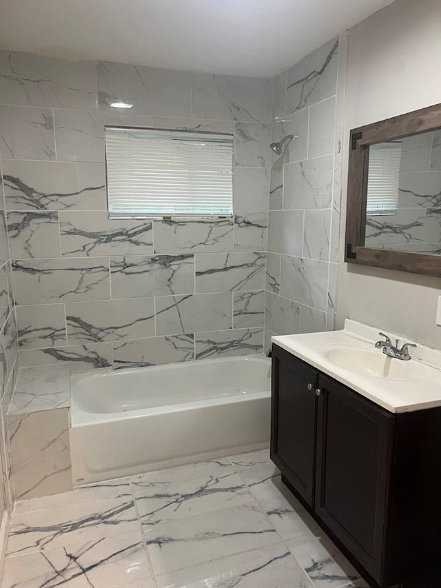 bathroom with vanity and tiled shower / bath