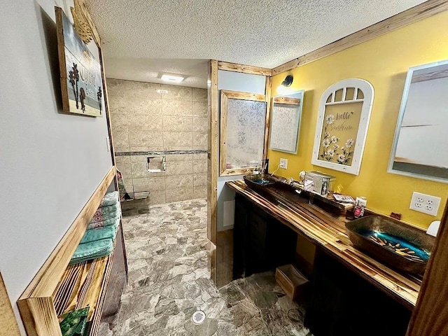 283 Roberts Rd, Hahira, GA 31632 - bathroom featuring double vanity, a textured ceiling, a tile shower, and stone finish flooring