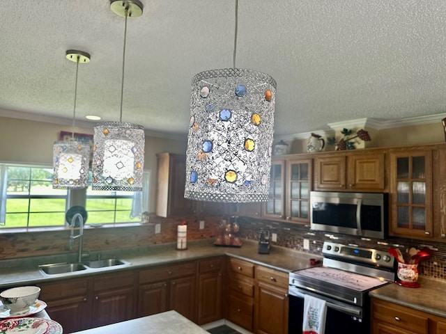 283 Roberts Rd, Hahira, GA 31632 - kitchen with appliances with stainless steel finishes, a sink, a textured ceiling, crown molding, and decorative backsplash