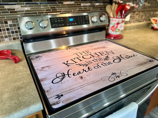 283 Roberts Rd, Hahira, GA 31632 - kitchen view of stainless steel range with electric cooktop and tasteful backsplash