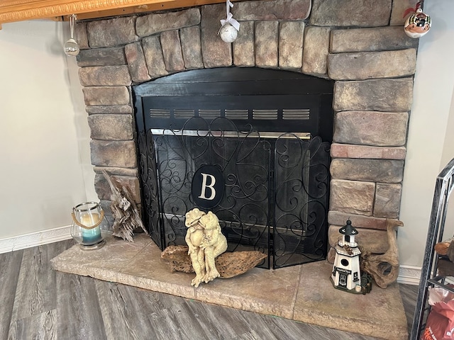 283 Roberts Rd, Hahira, GA 31632 - detailed view of baseboards, a stone fireplace, and wood finished floors