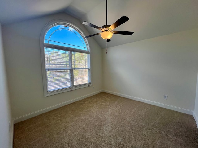 unfurnished room with vaulted ceiling, ceiling fan, and carpet flooring