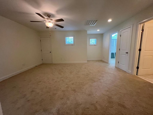 carpeted empty room featuring ceiling fan