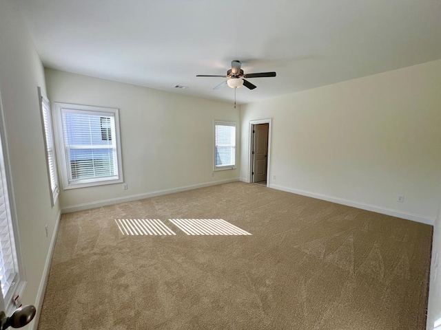 carpeted empty room featuring ceiling fan