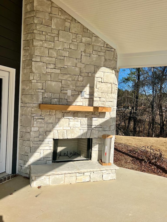 details with an outdoor stone fireplace